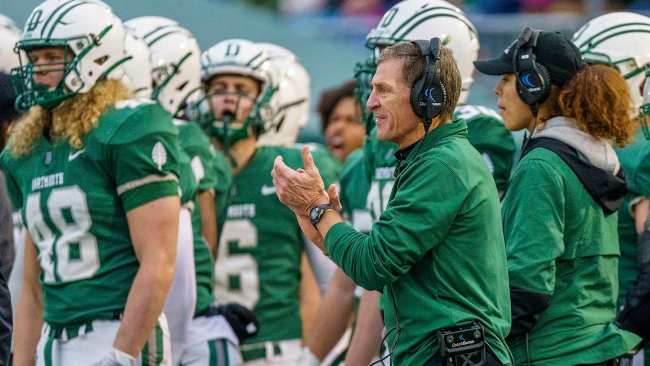 Photo of Dartmouth head football coach Eugene 'Buddy' Teevens on the sideline with his team during a game in 2019