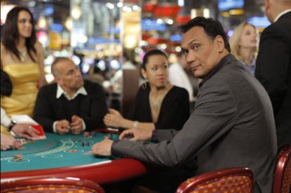 Scene from the TV show Outlaw. Star Jimmy Smits is sitting at a table gambling in a casino and looking over his shoulder