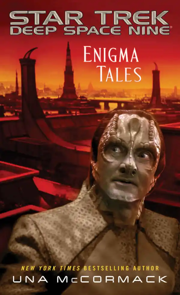Cover of the book Star Trek Deep Space Nine: Enigma Tales by Una McCormack depicting the Cardassian Elim Garak in front of an orange-tinted city on Cardassia